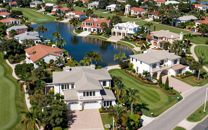 Aerial view of Isleworth gated community with lakefront mansions and golf course in Orlando