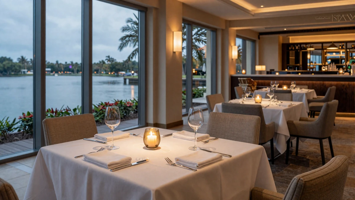 Elegant fine dining table at a luxury Orlando resort with floor-to-ceiling lake views and warm candlelight